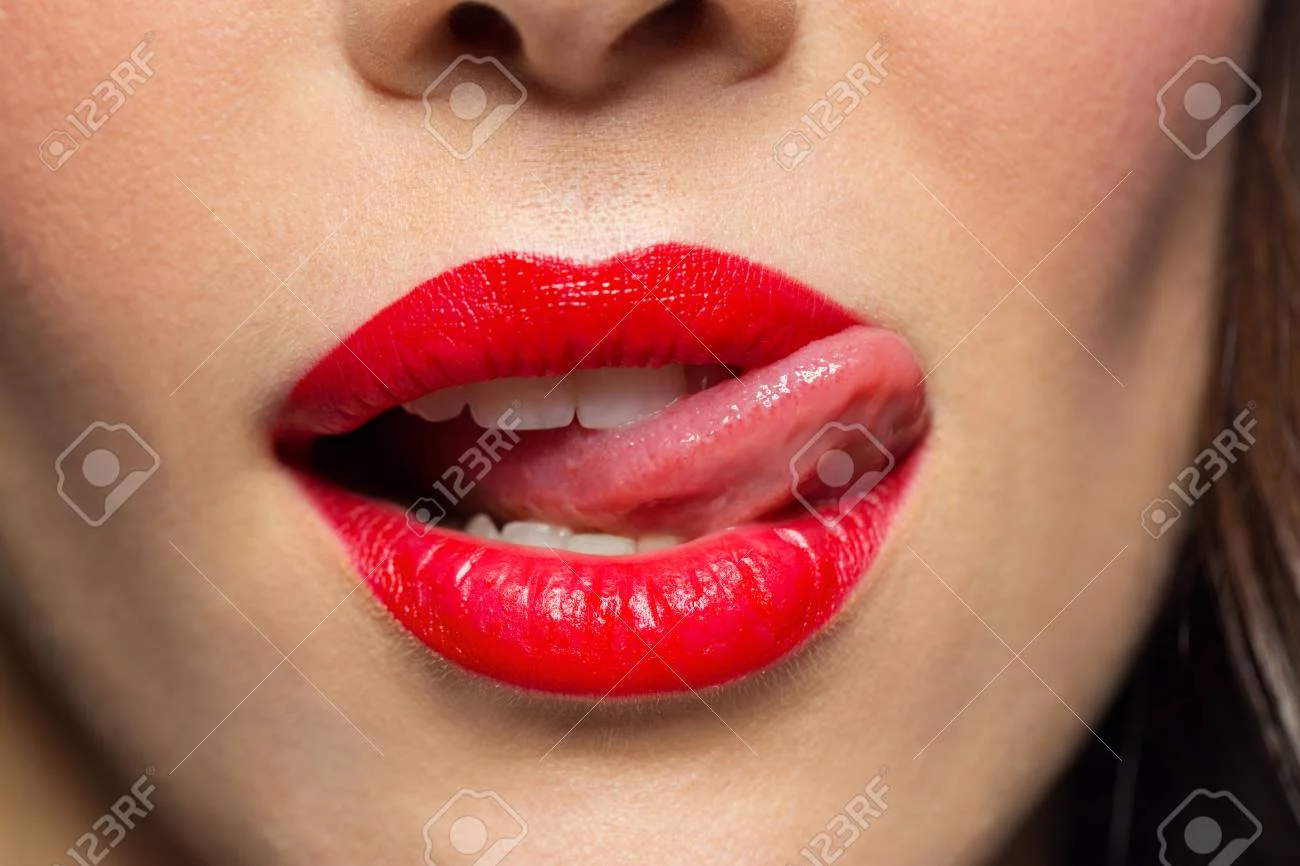 4-close-up-of-woman-with-red-lipstick-licking-lips.webp