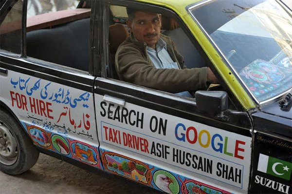 Asif-hussain-Shah-with-his-Taxi.webp