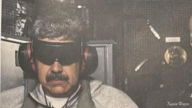 Nicolás Maduro shown after his arrest, wearing headphones and a blindfold, grey zipped jumper