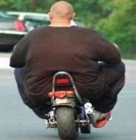 fat-man-on-motorcycle.webp