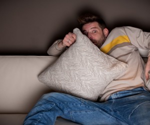 frightened-man-watching-a-horror-movie-300x250.jpg