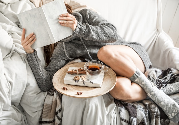 girl-on-the-couch-with-tea-and-a-book_169016-1844.jpg