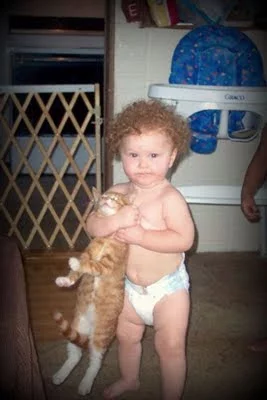 kid-holding-cat-tight.webp