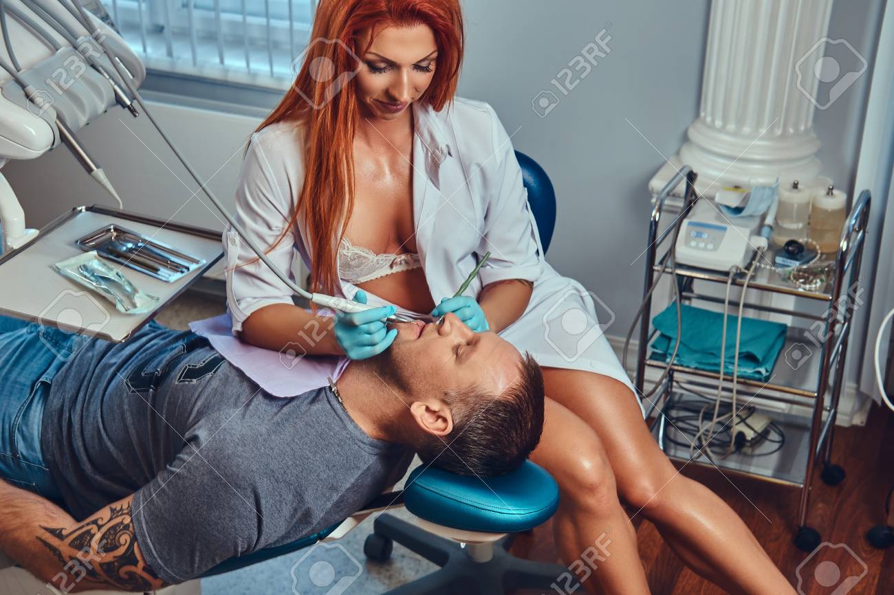 -redhead-dentist-woman-taking-care-of-her-patient-.jpg