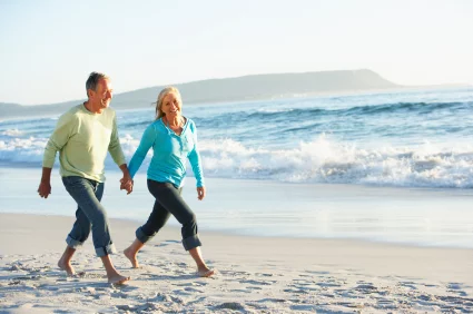retired+couple+on+beach.webp