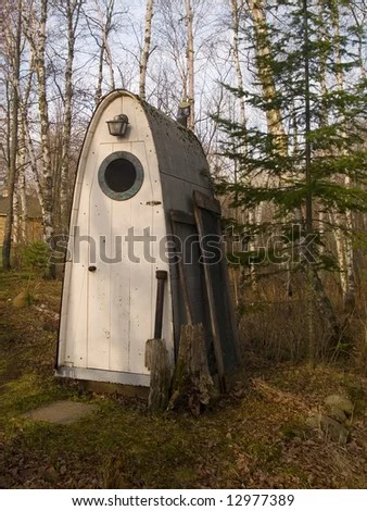 shaped-outhouse-in-the-woods-of-minnesota-12977389.webp