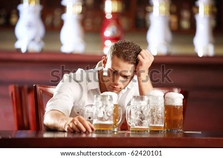 tock-photo-drunk-man-with-a-beer-in-a-pub-62420101.webp